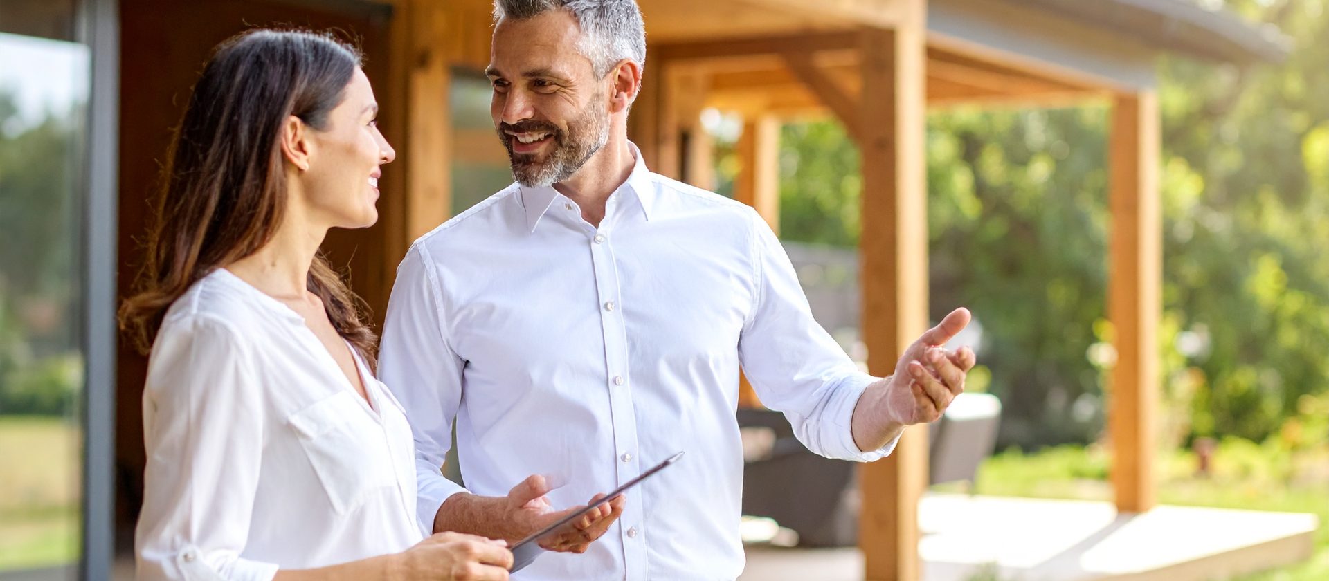 A home adviser reviewing an upcoming project on site with a homeowner.